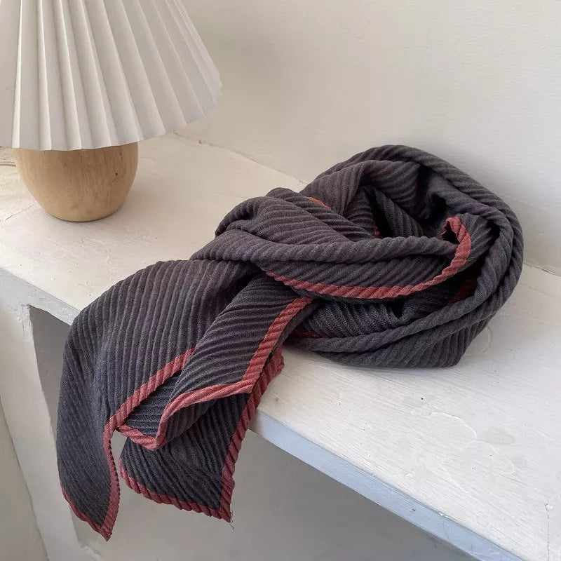 Contrast trim texture scarf draped over a coat