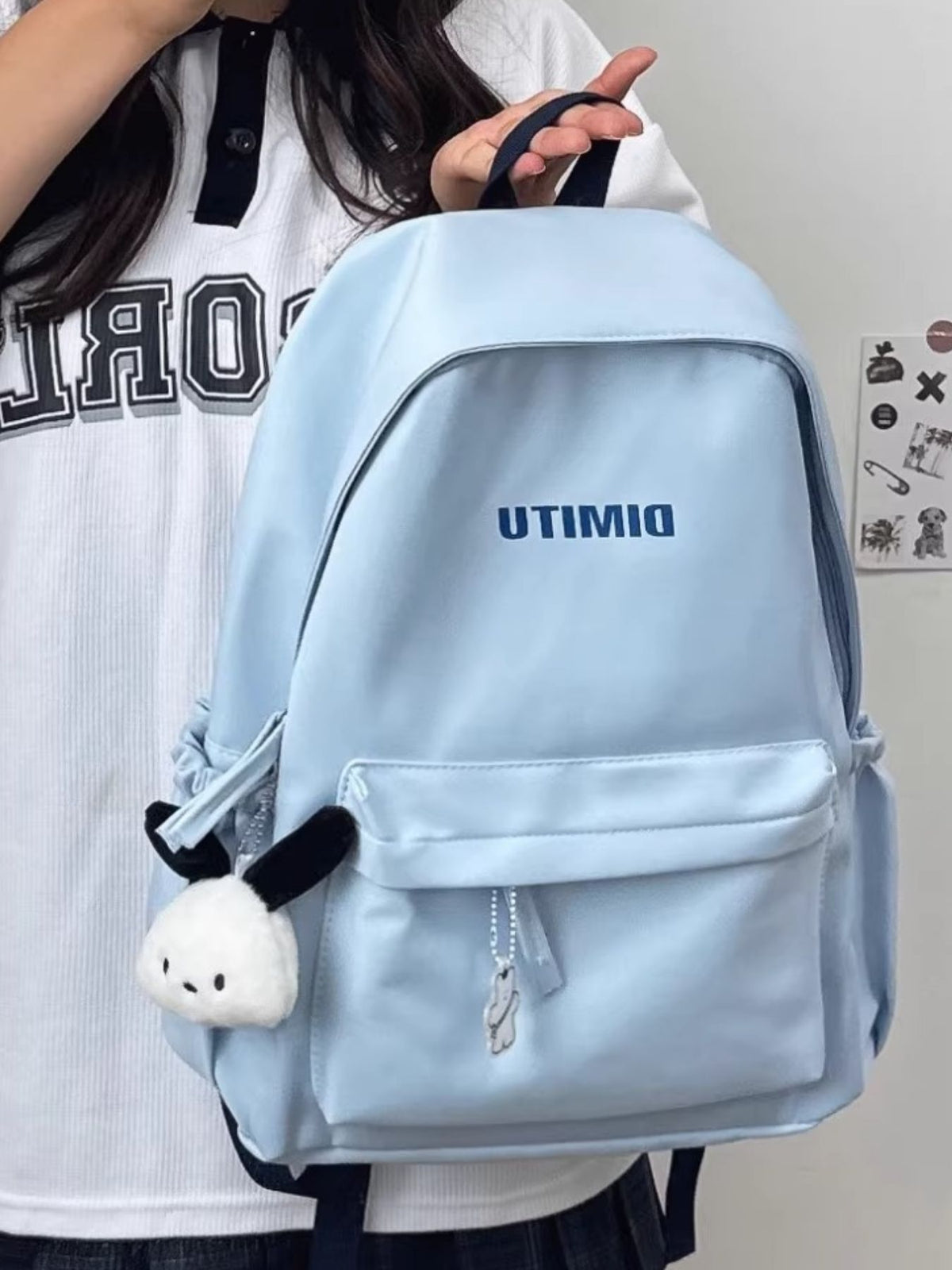 light blue nylon backpack top handle and zip detail