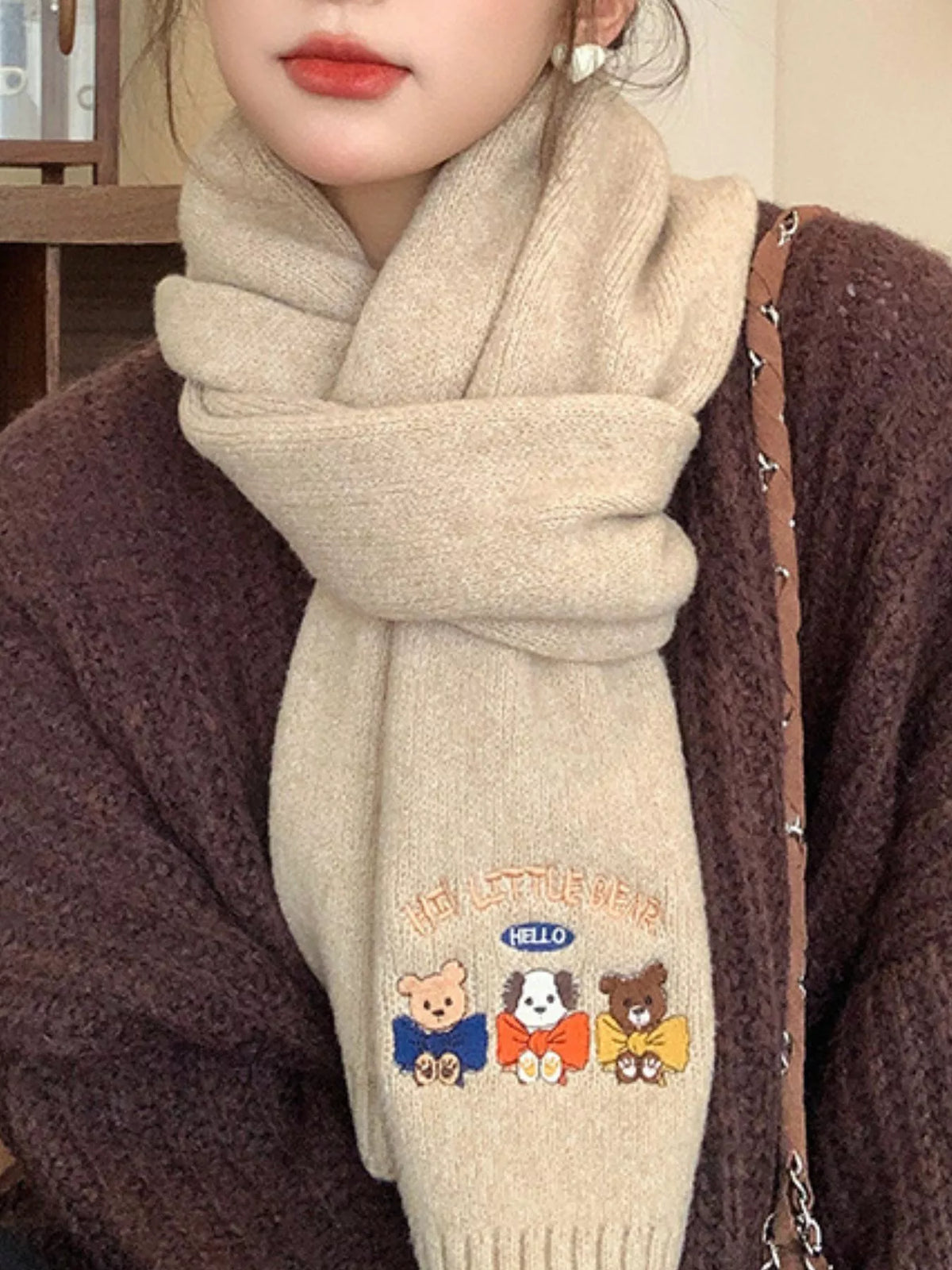 Embroidered cartoon scarf styled with a winter coat