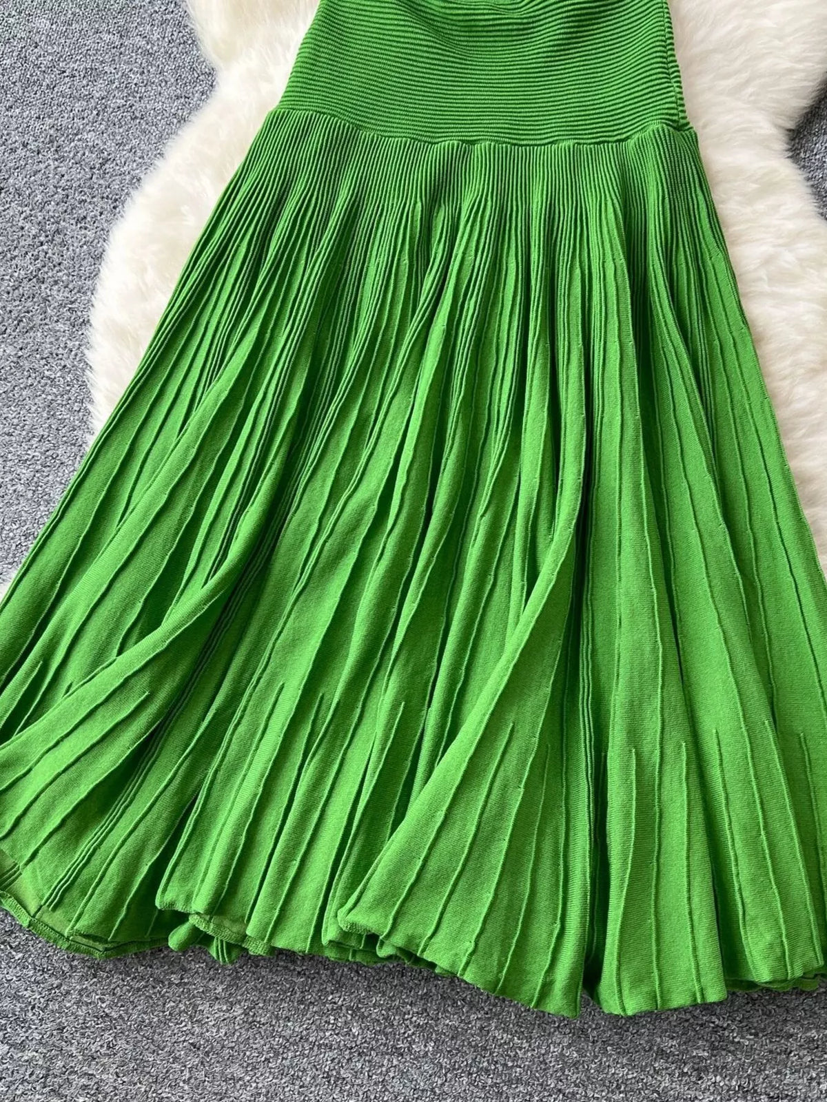Green textured knit dress fabric detail