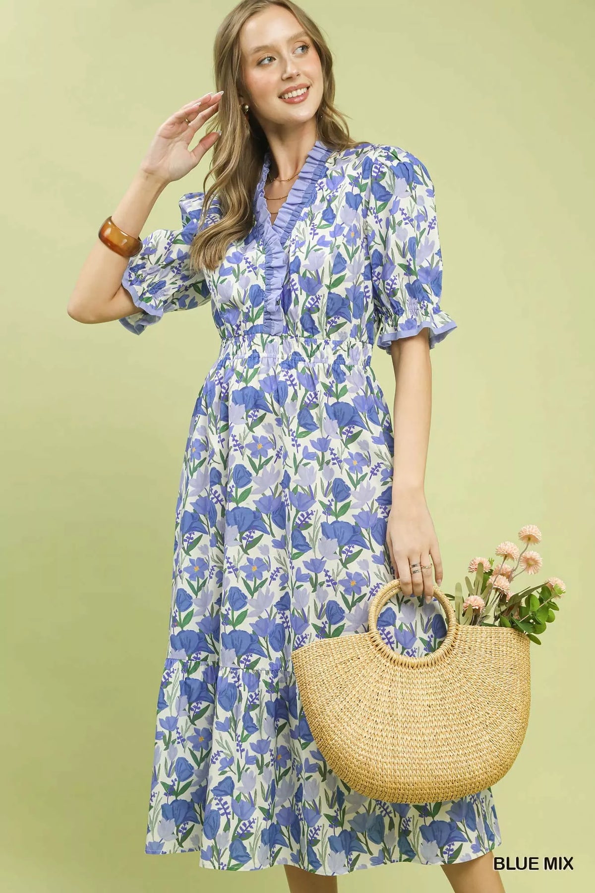 Blue floral tiered midi dress with ruffle trim worn with a straw basket bag