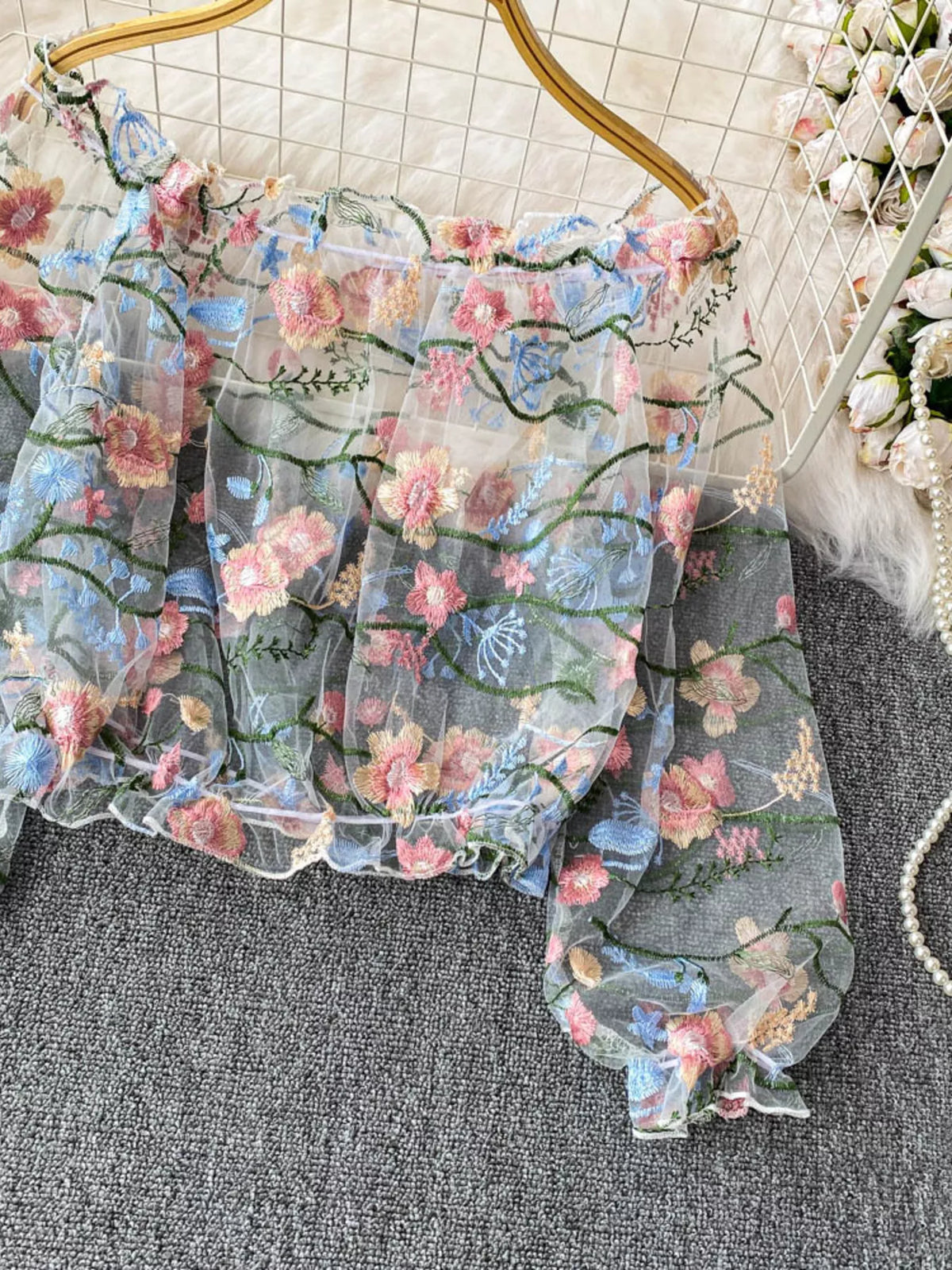 Embroidered off shoulder top detail view