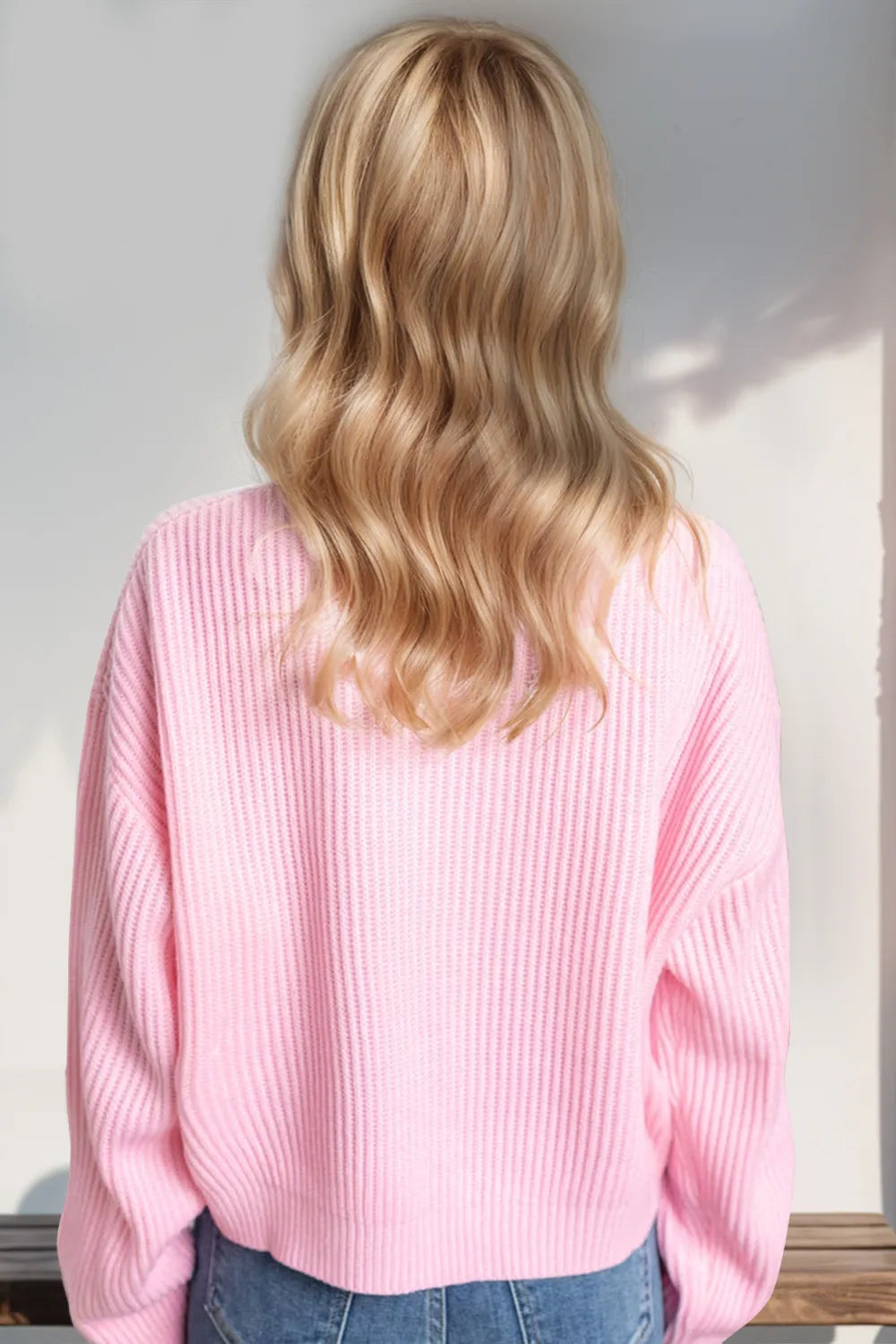 Cropped holiday sweater side view showing dropped shoulder