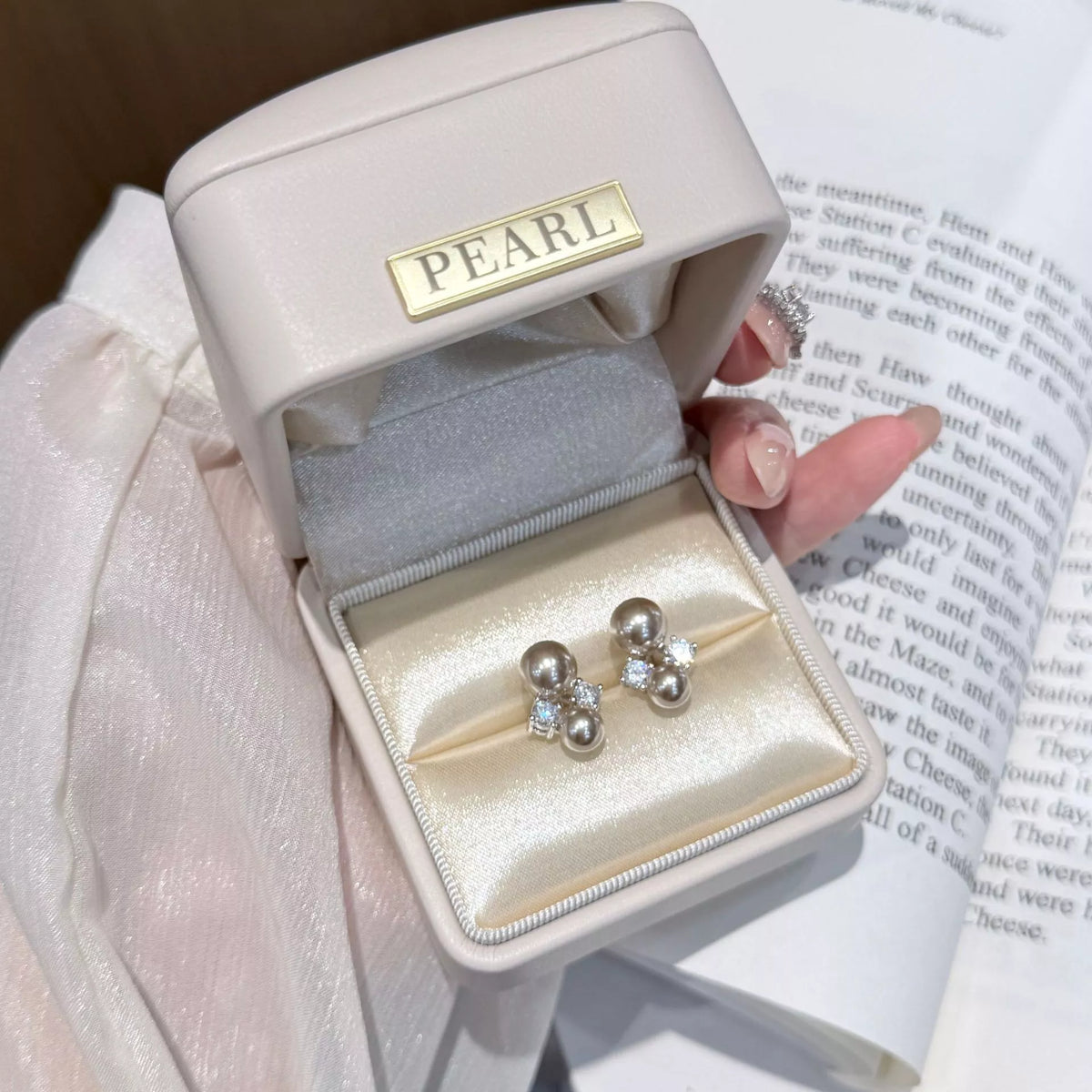 Silver pearl stud earrings detail view