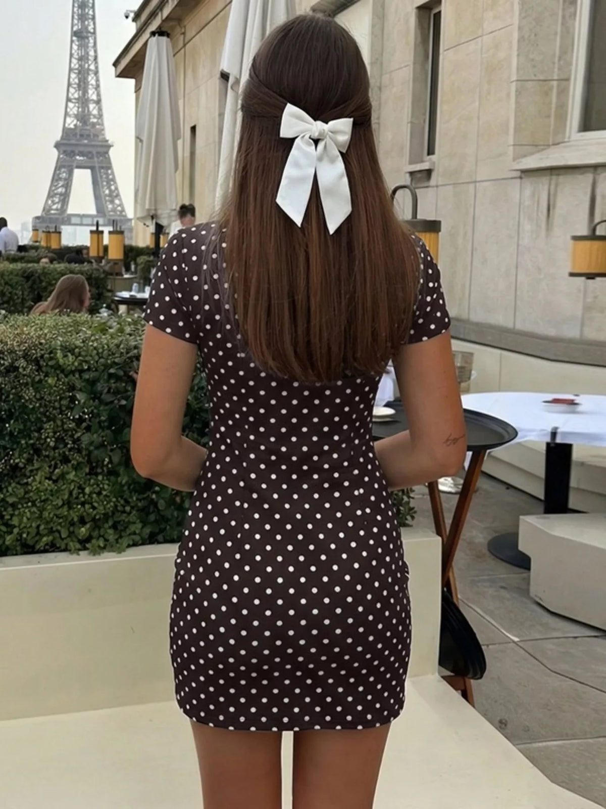 Neckline detail on polka dot cutout dress