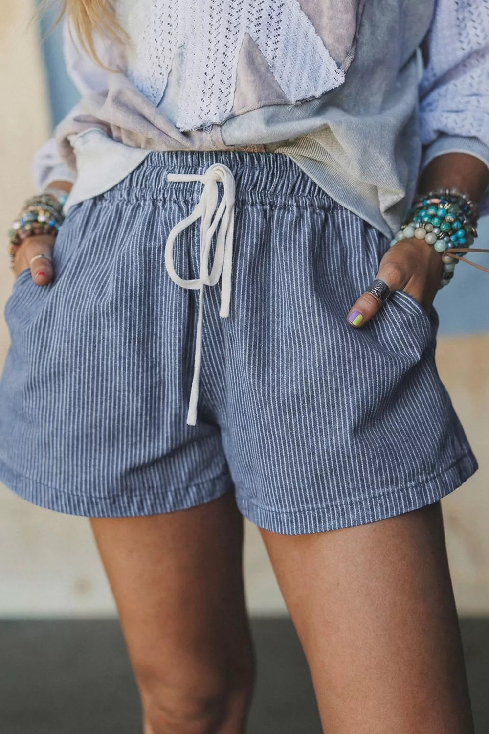 Dusty blue striped drawstring denim shorts front view