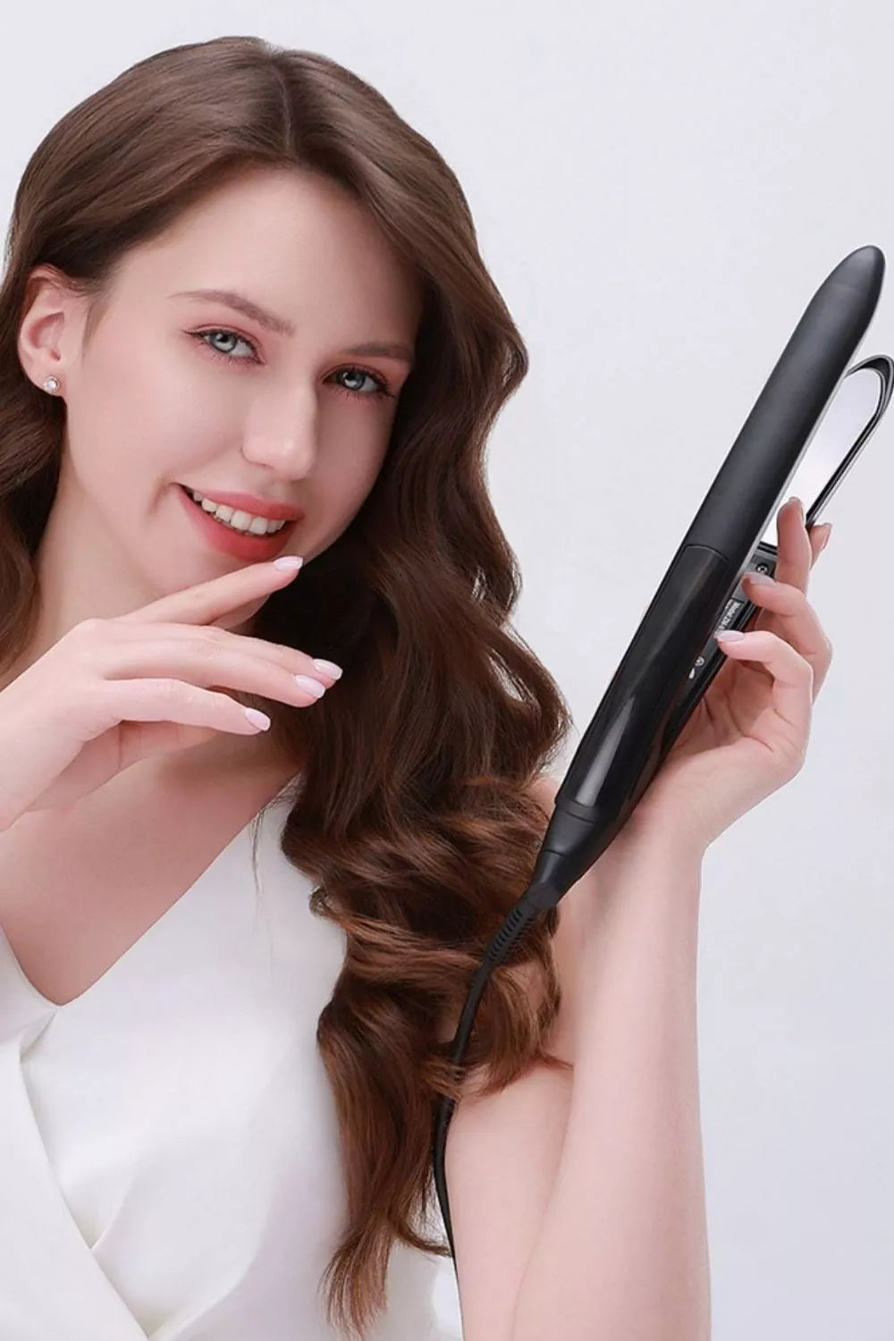 Styling iron shaping a curl