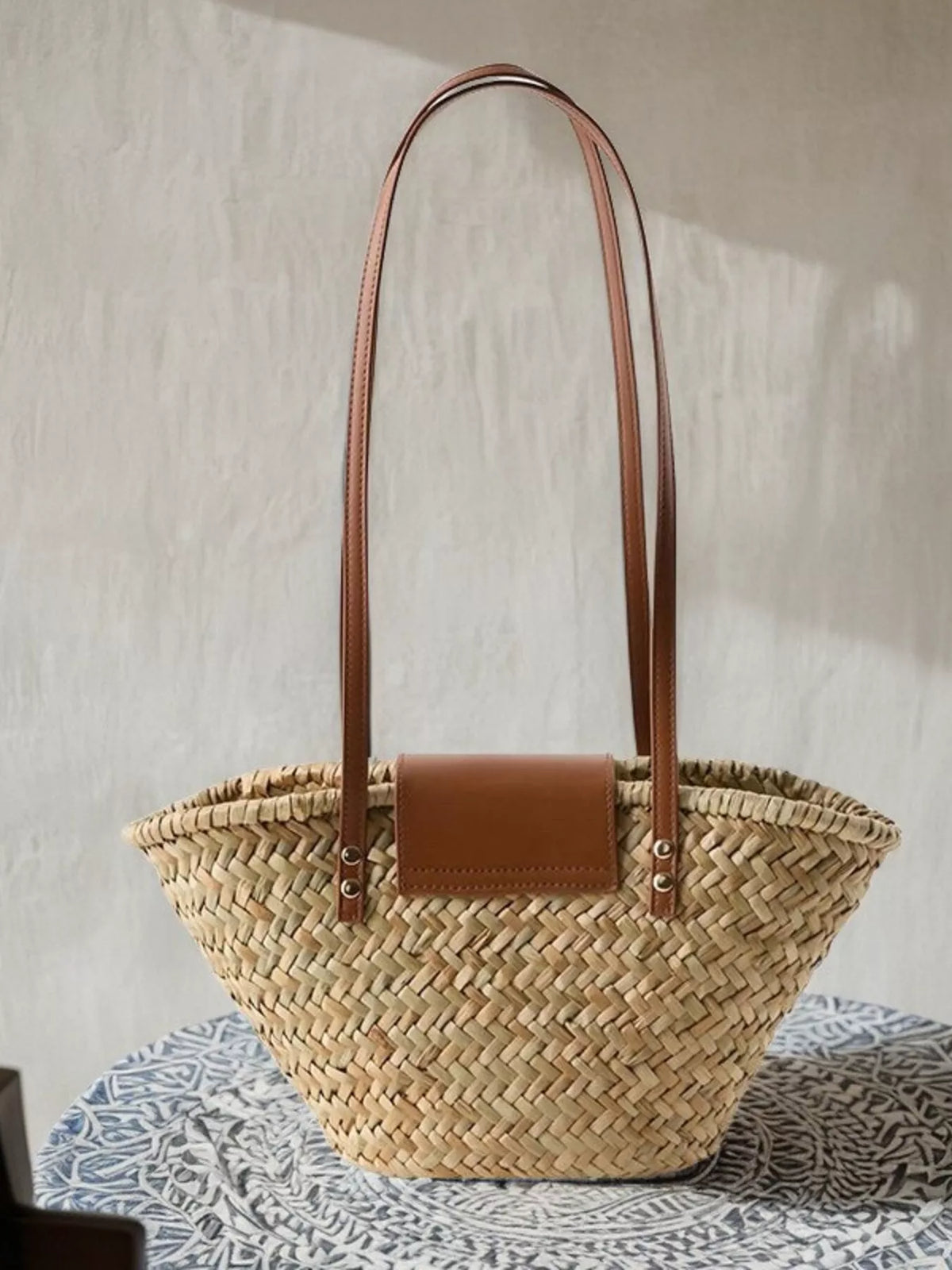 Close up of woven straw and leather accent