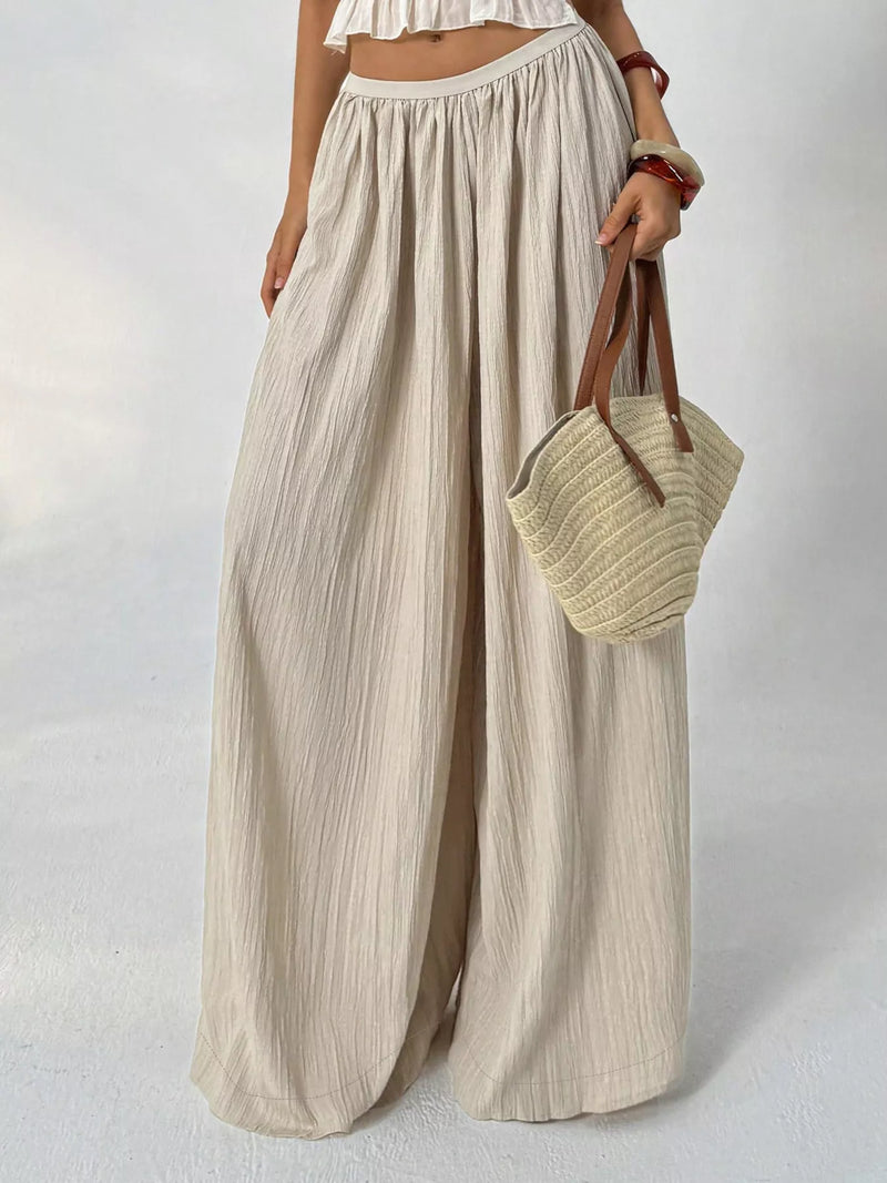 Khaki wide leg textured pants shown full length from the front