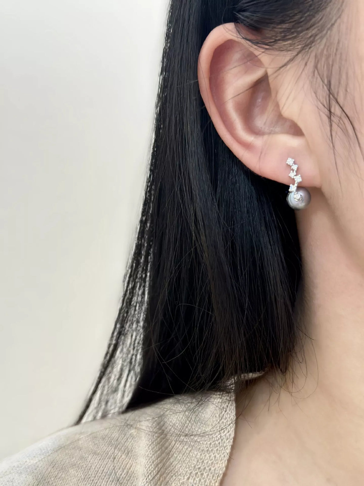 Sterling silver pearl earrings worn on ear