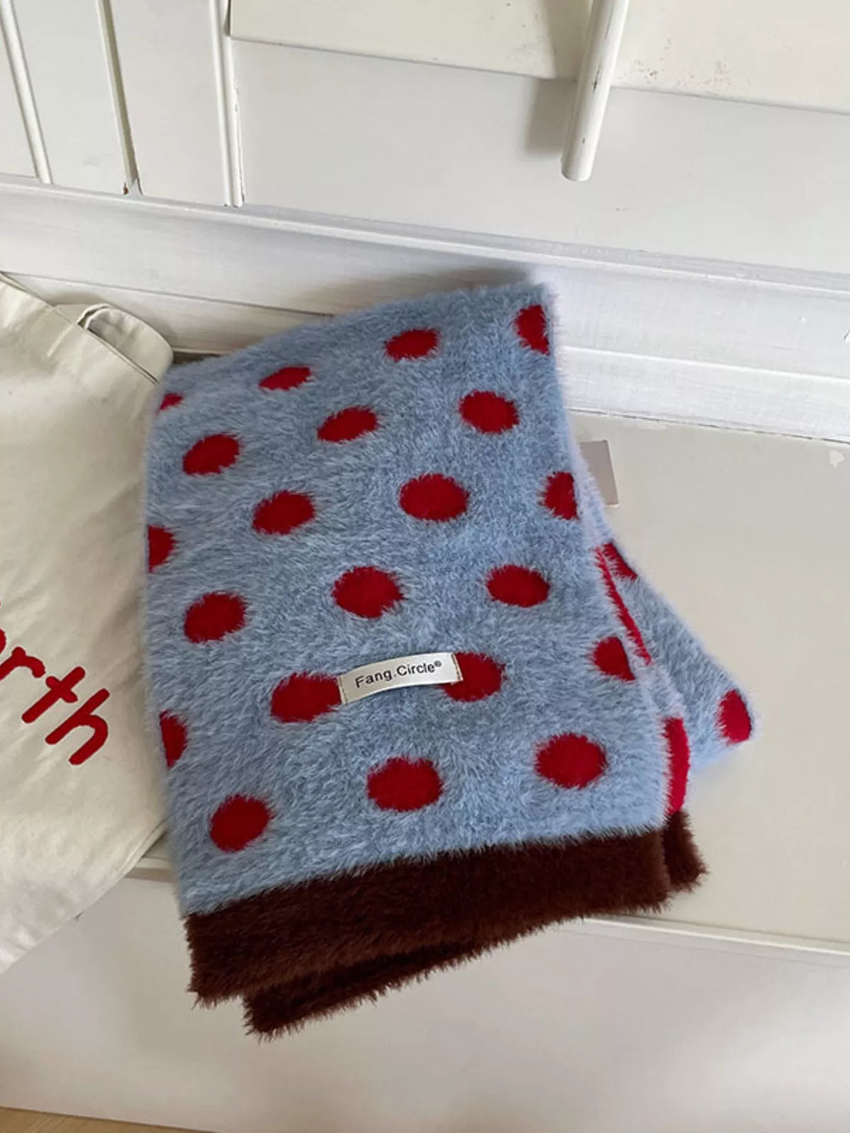 Fuzzy scarf displayed full length in blue