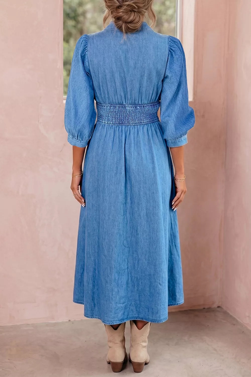 Close up of the zipper and v neckline on the denim dress