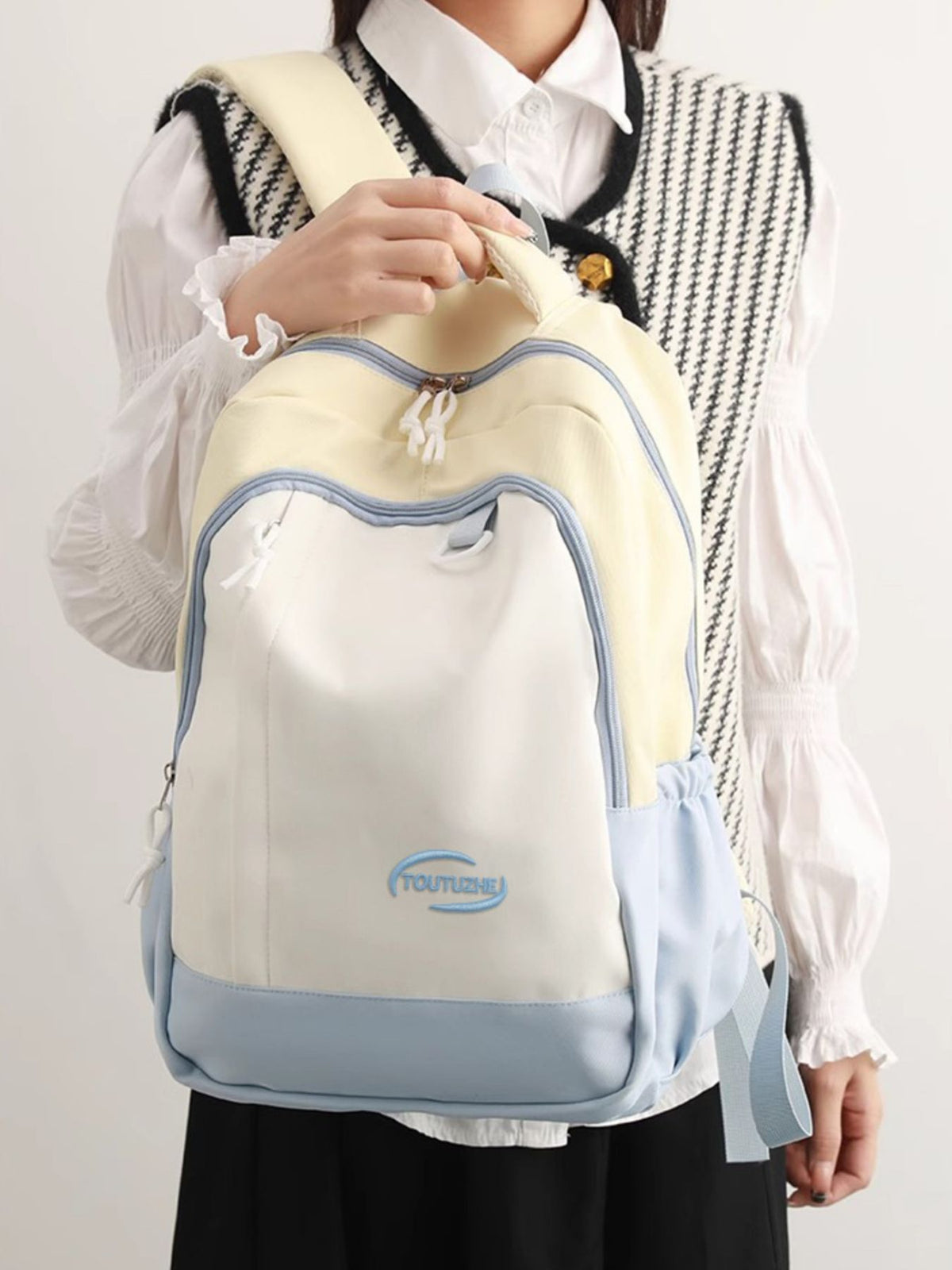 Pastel yellow color block nylon backpack front view