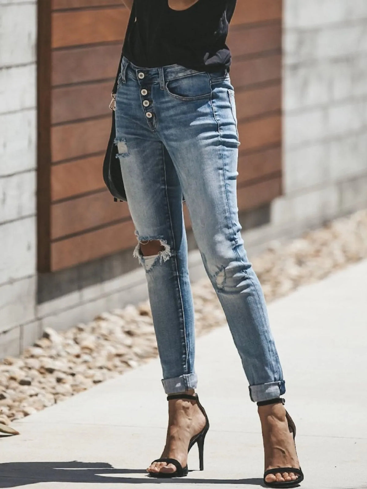 Close up of distressing on light blue skinny jeans