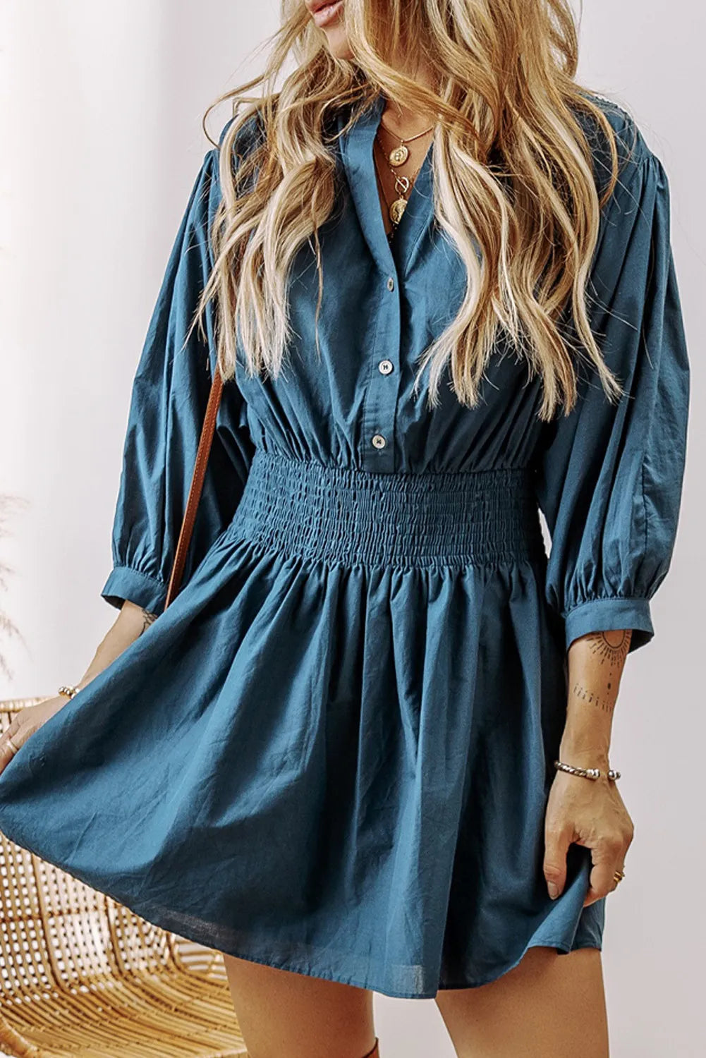 Blue half button mini dress side view on model