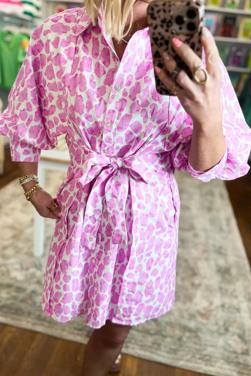 Puff sleeve and button front detail on a pink leopard print mini dress