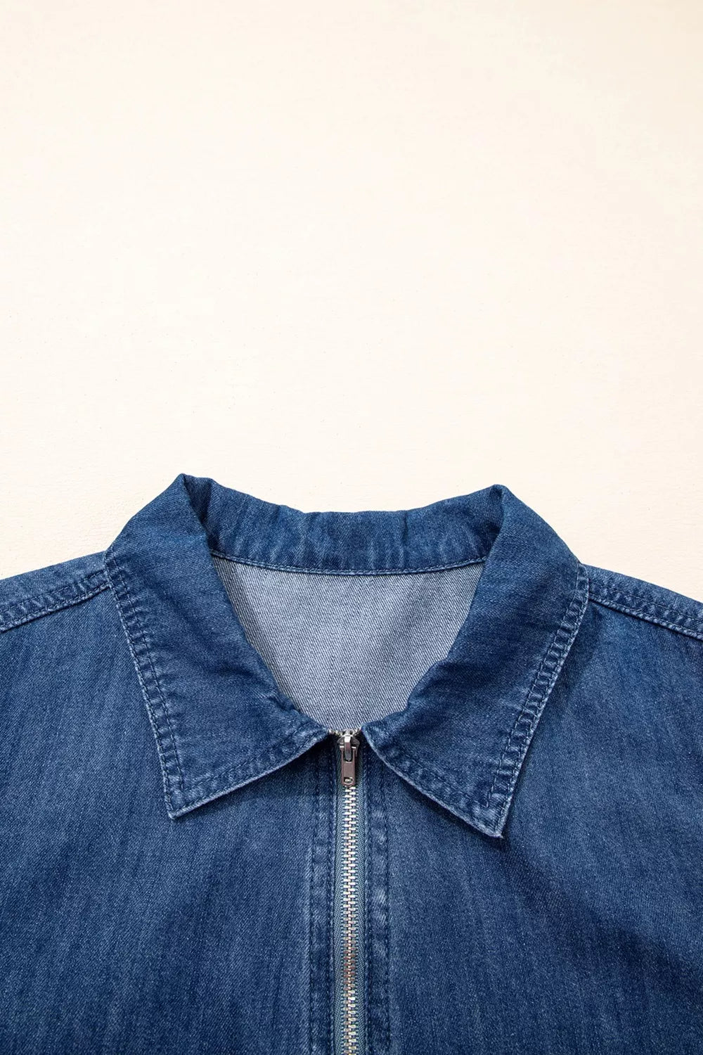 Dark blue zip up collared denim mini dress close up view