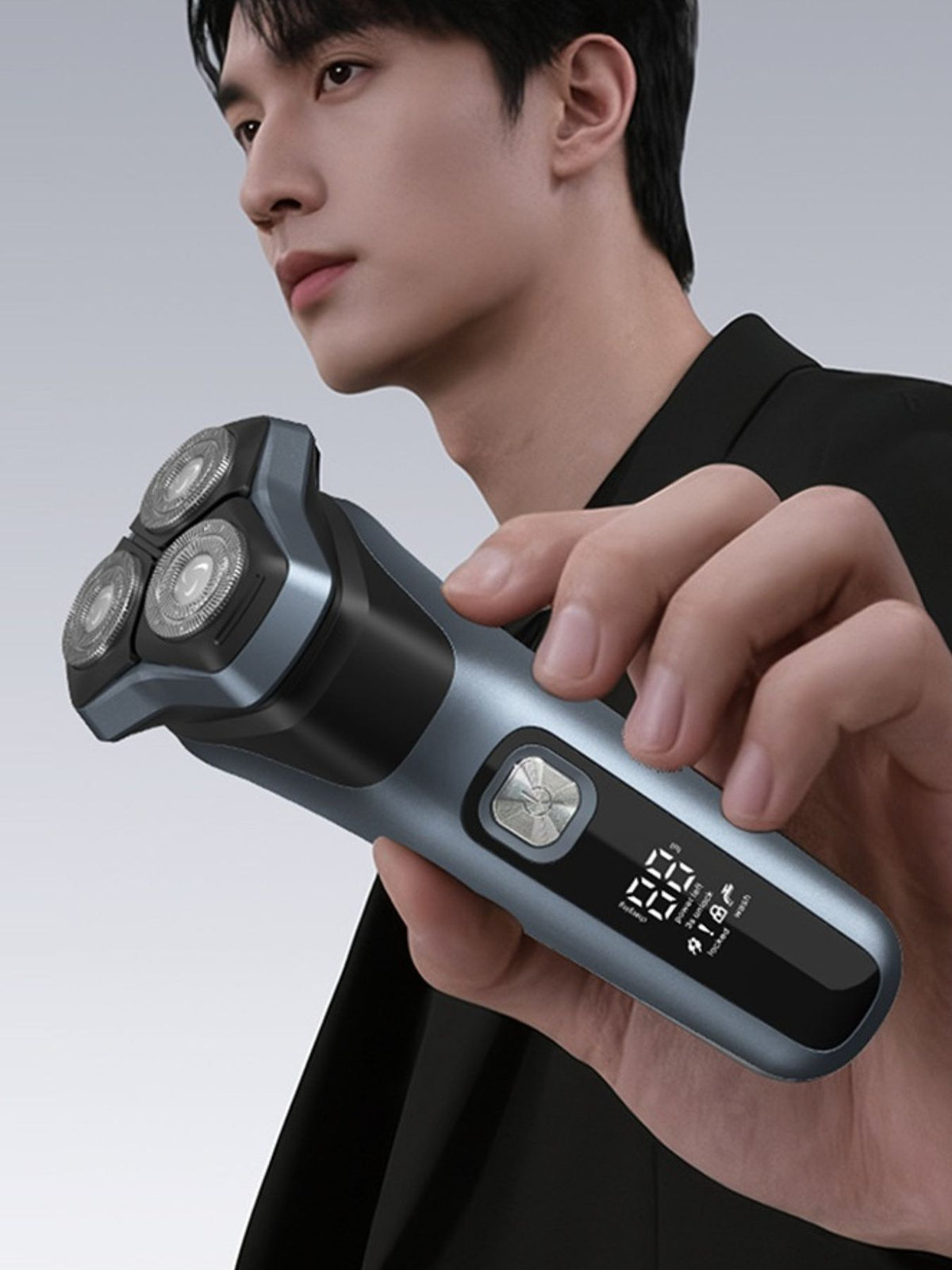 Man using rotary electric shaver on face