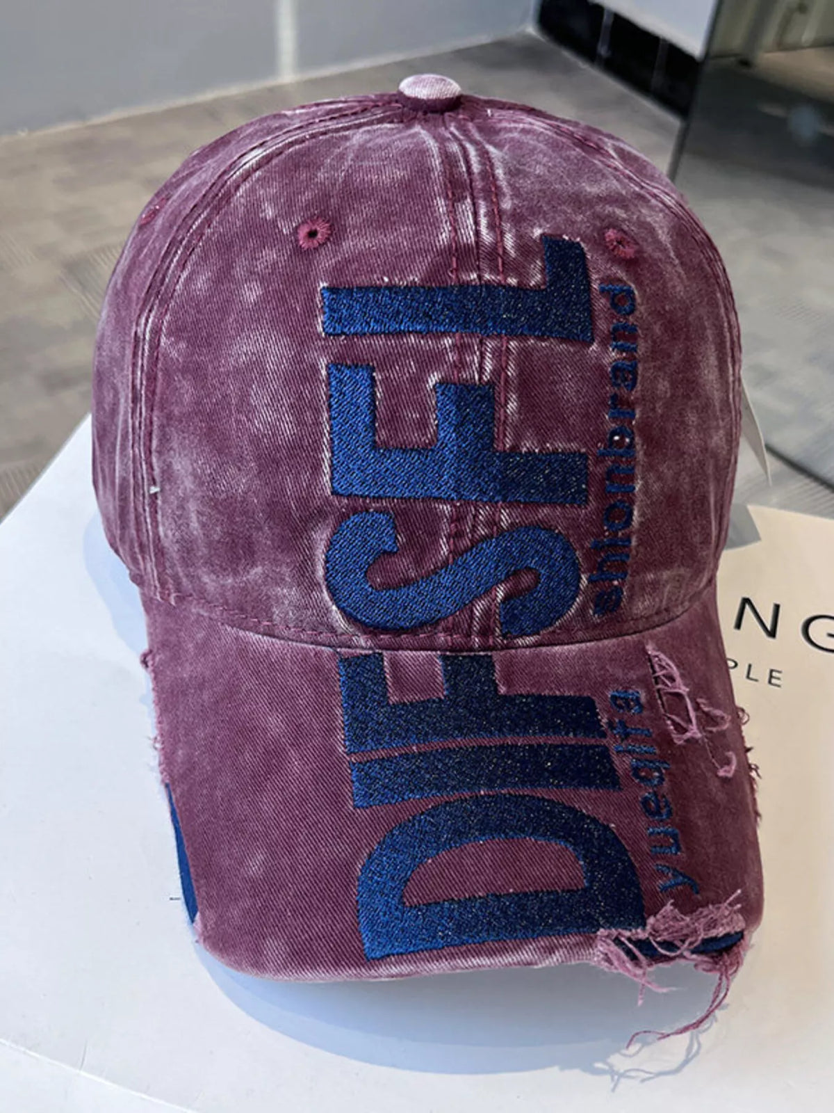 Detail of the distressed brim edge on the cotton cap
