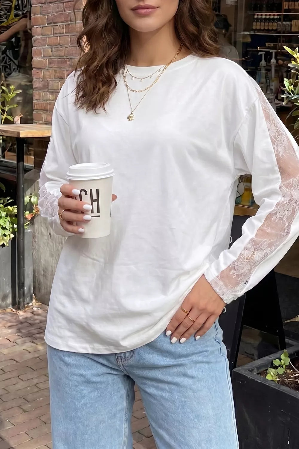 White lace patchwork long sleeve top shown on a model