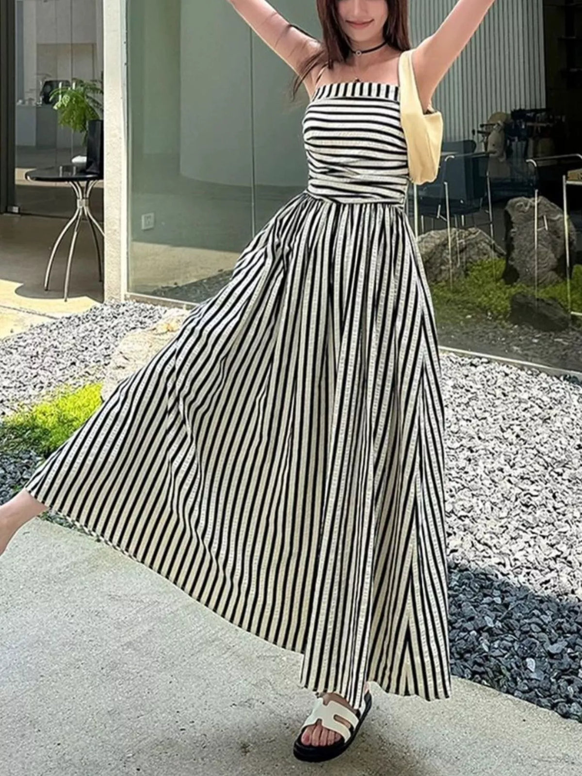Striped maxi dress styled with tote