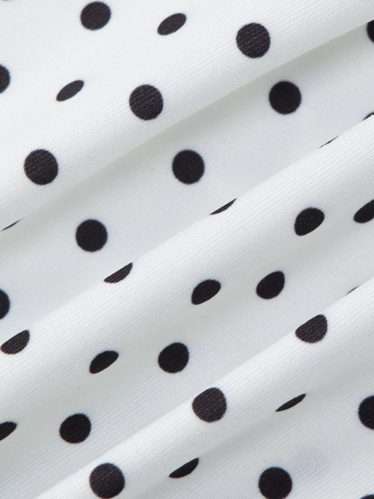 Polka dot top shown flat to display the cut