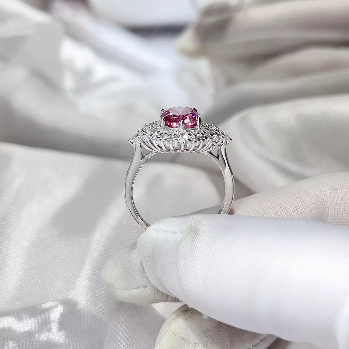 Two carat pink moissanite ring worn on the hand
