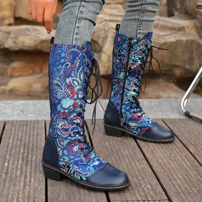 Embroidered knee high boots pair standing together