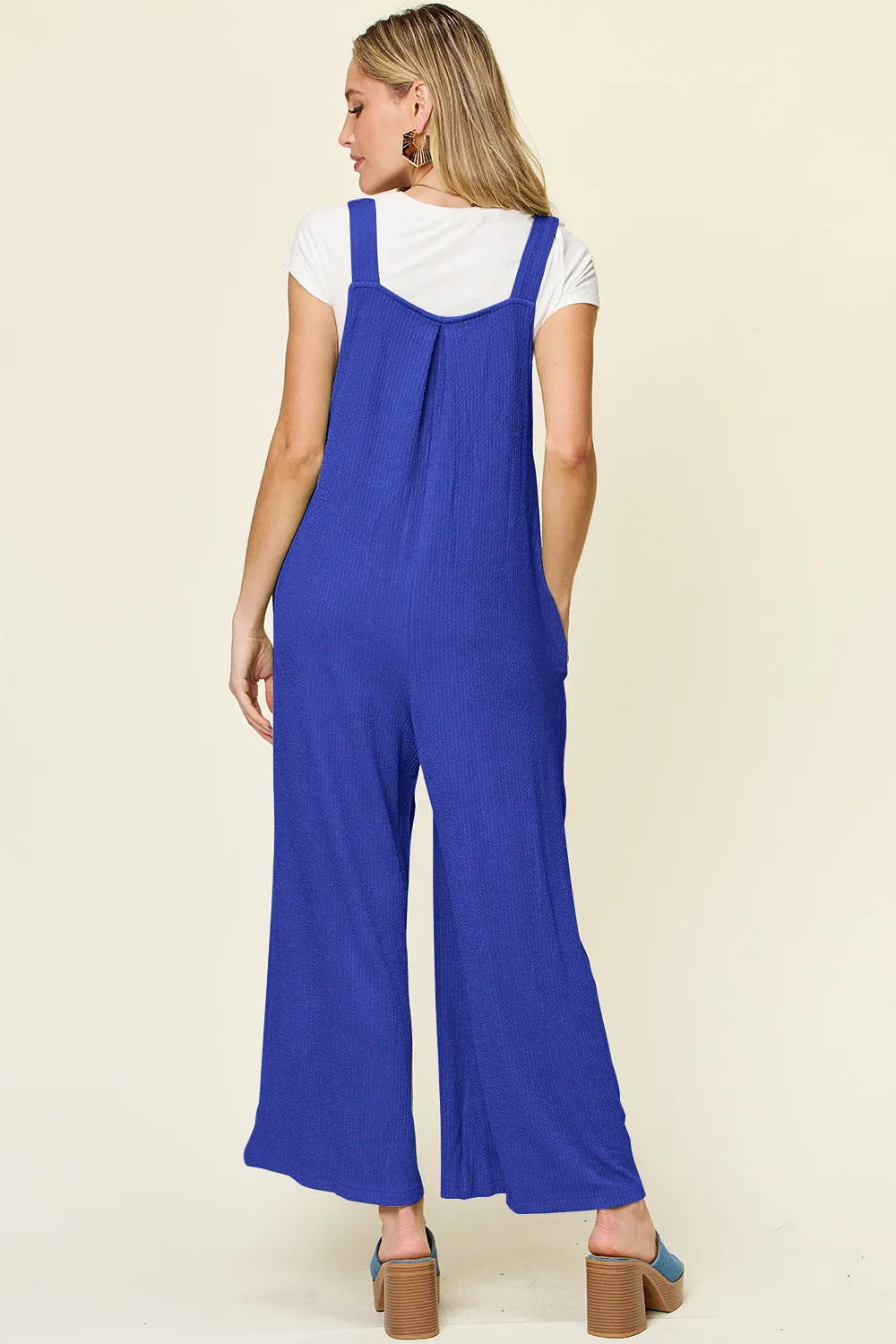 Sleeveless overall side profile view