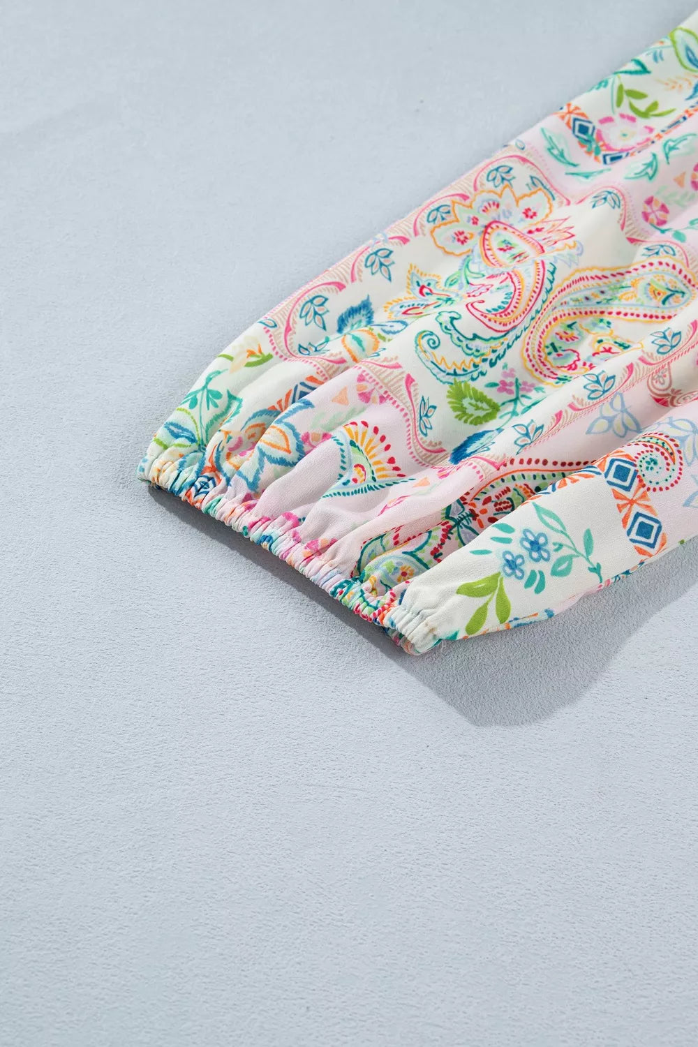 Blush pink floral print belted mini dress close up view