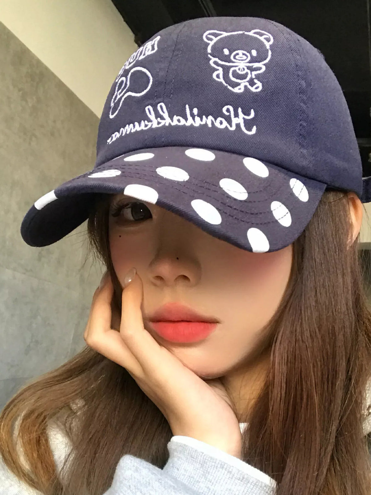 Embroidery detail on the polka dot baseball cap