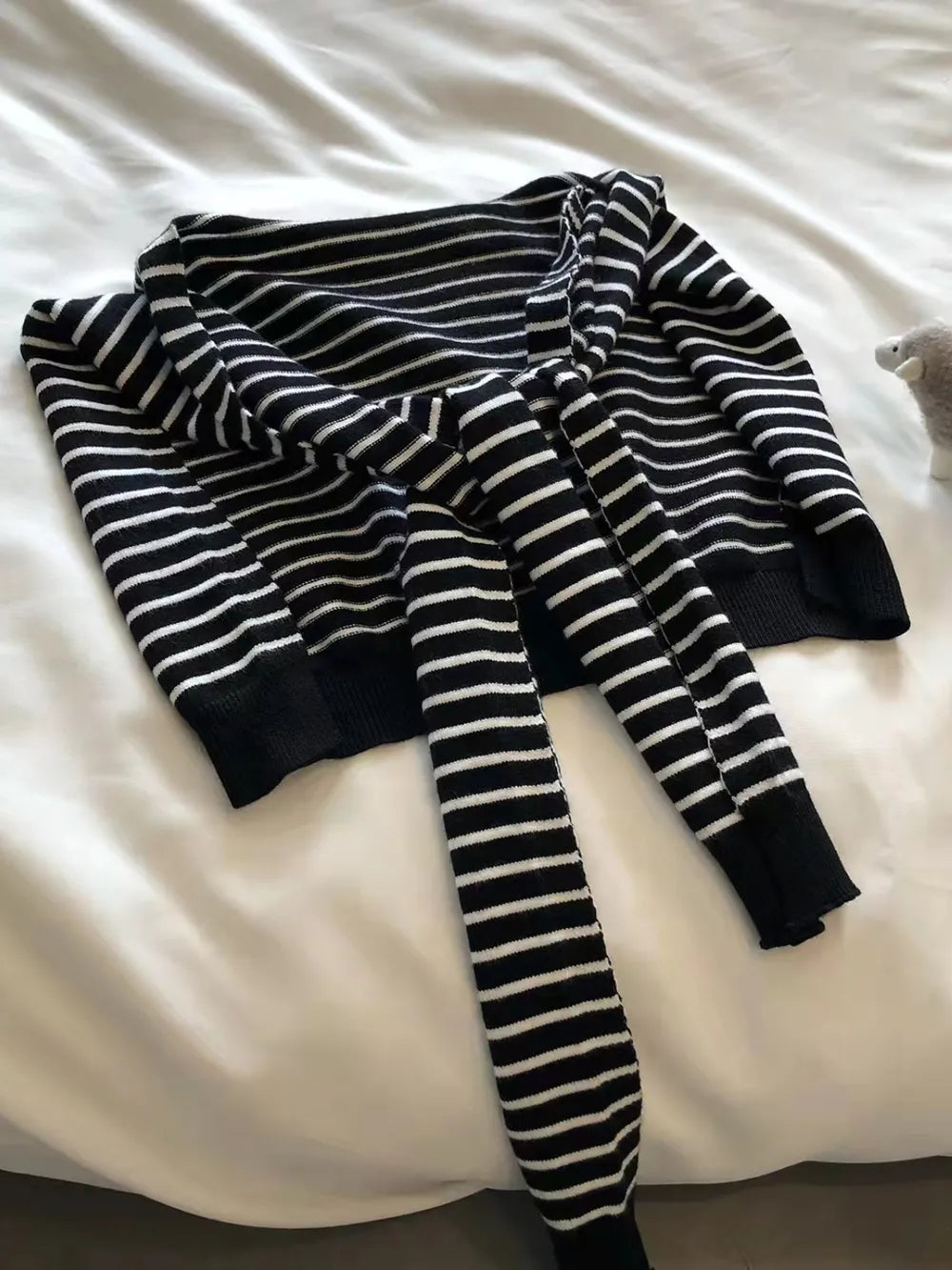 Striped contrast knit wrap draped over shoulders