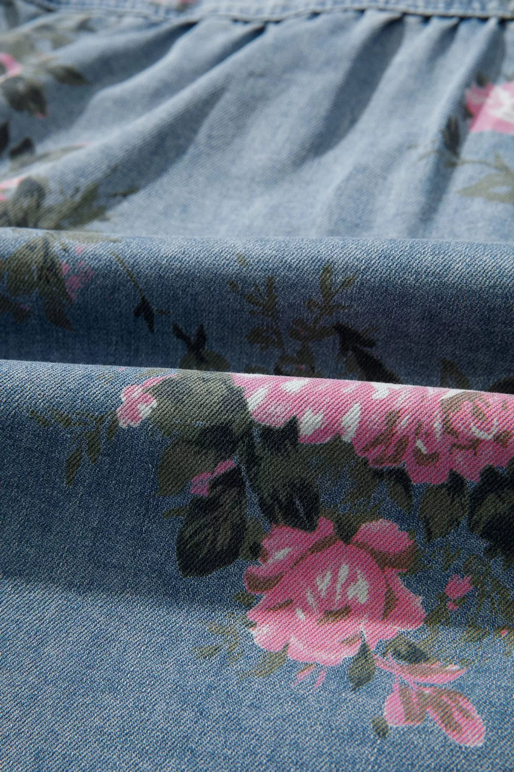 Oversized floral denim shirt worn open as a layer