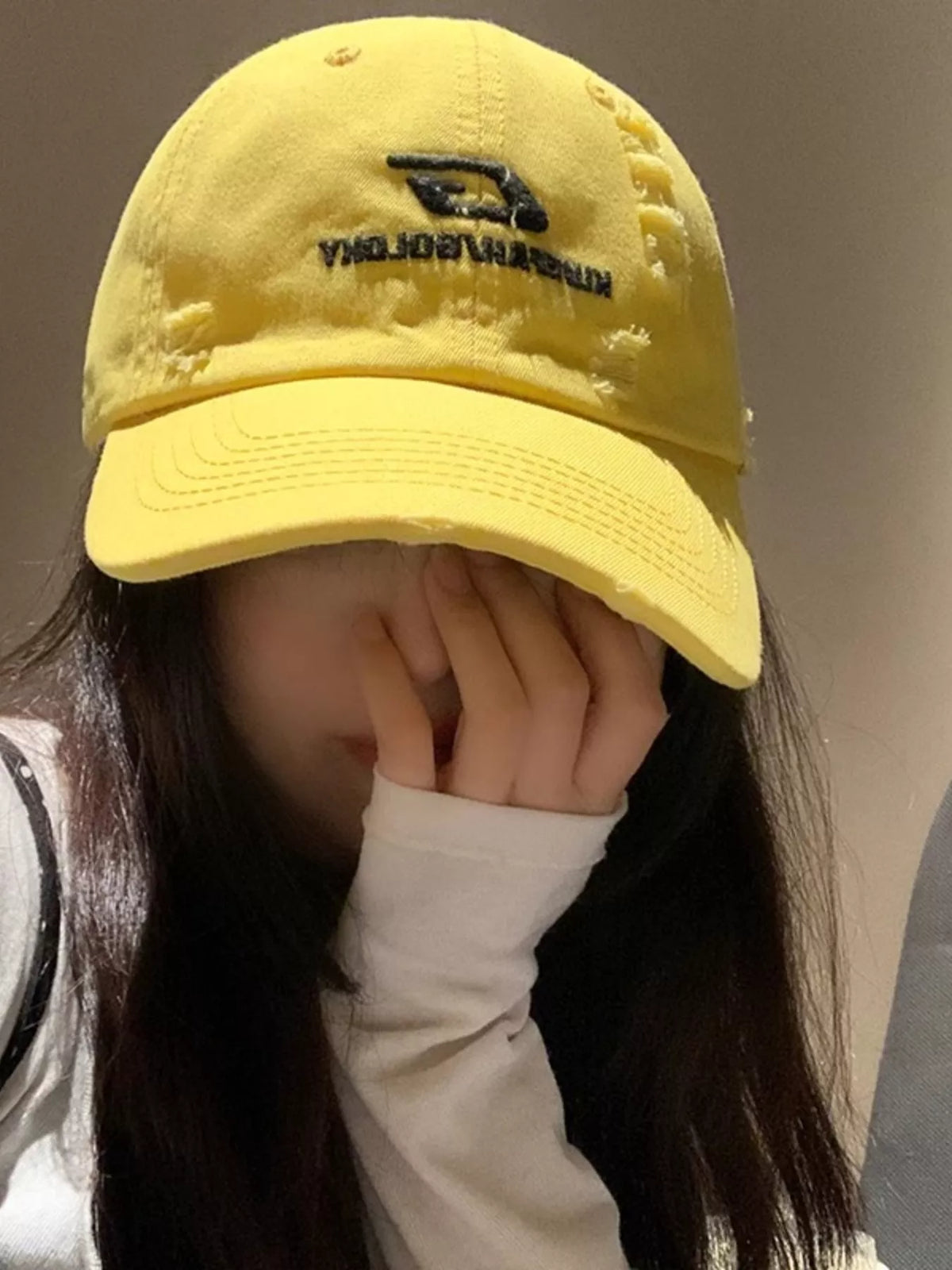Embroidery detail on yellow cotton cap