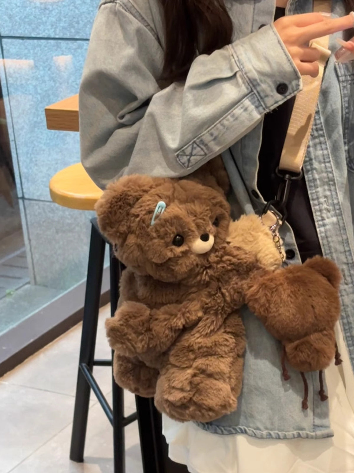 Dark brown plush teddy bear backpack side profile