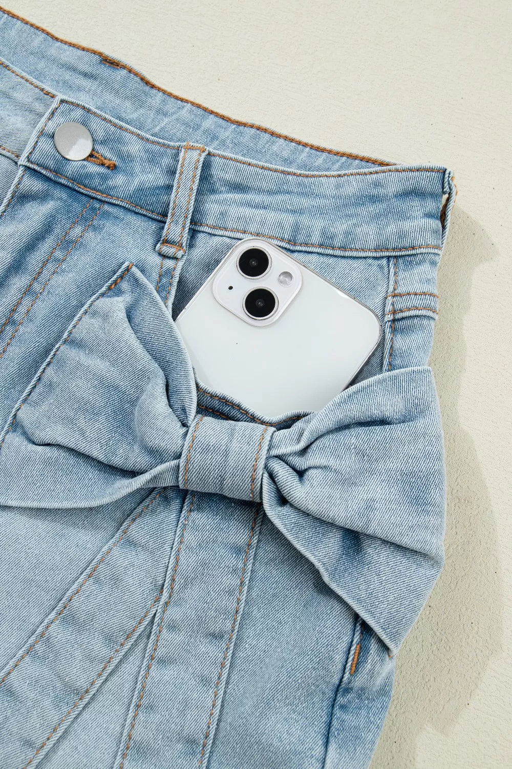 Light blue bow detail denim shorts front view