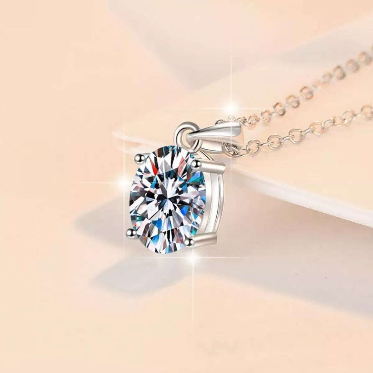 Sterling silver moissanite necklace shown worn at the collarbone