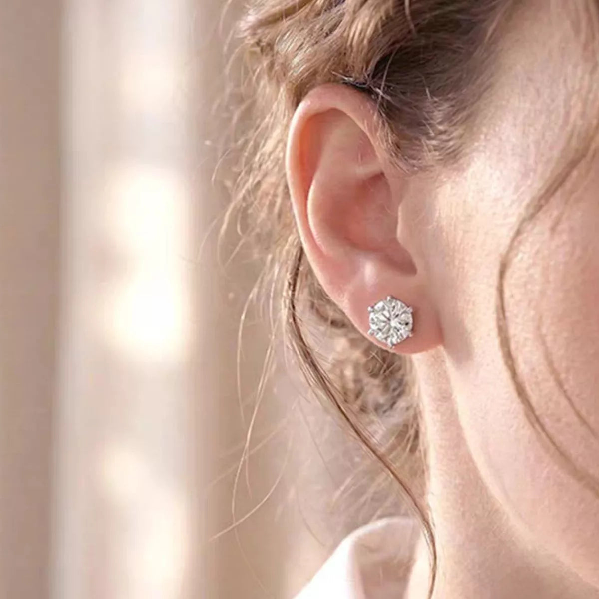 Moissanite stud earrings in sterling silver shown as a pair