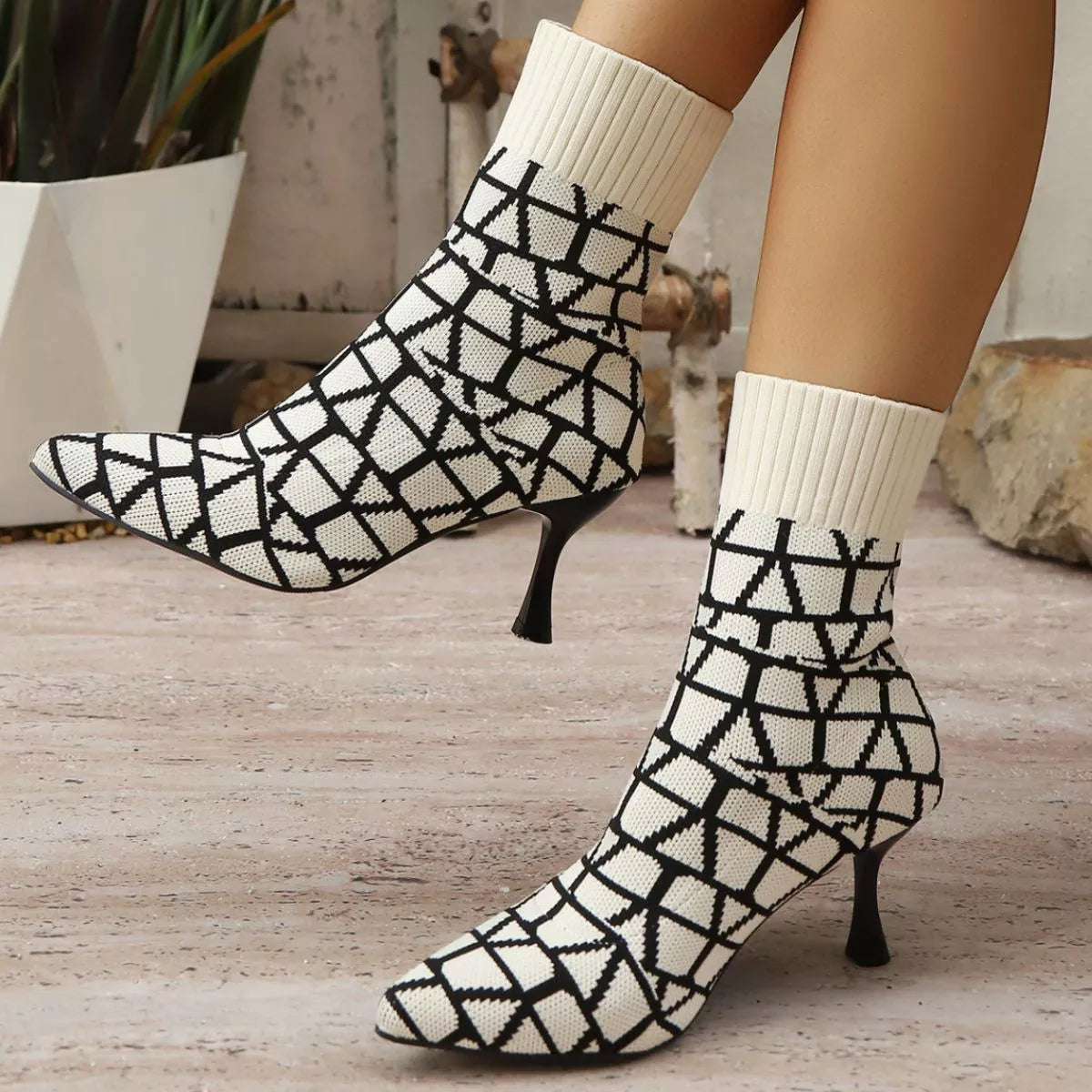 Off White point toe flared heel boots worn on model
