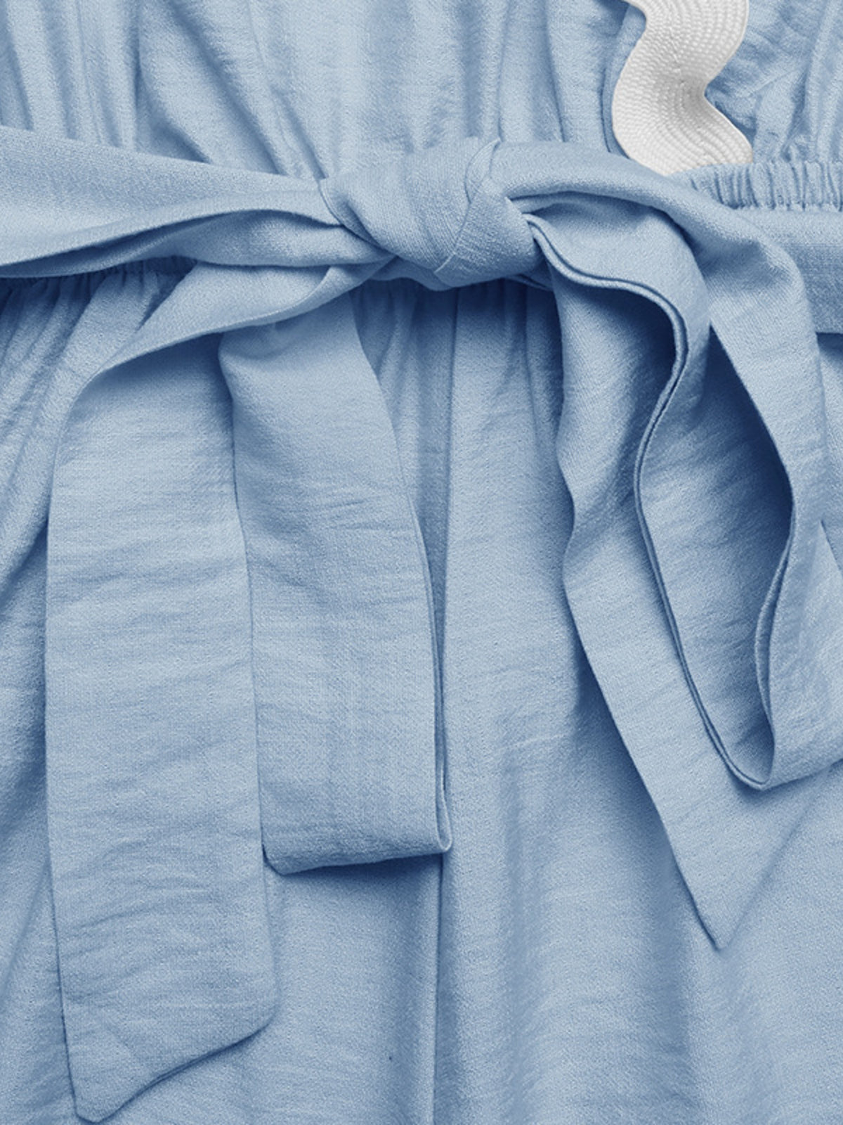 Wrap romper hem and scalloped edge detail