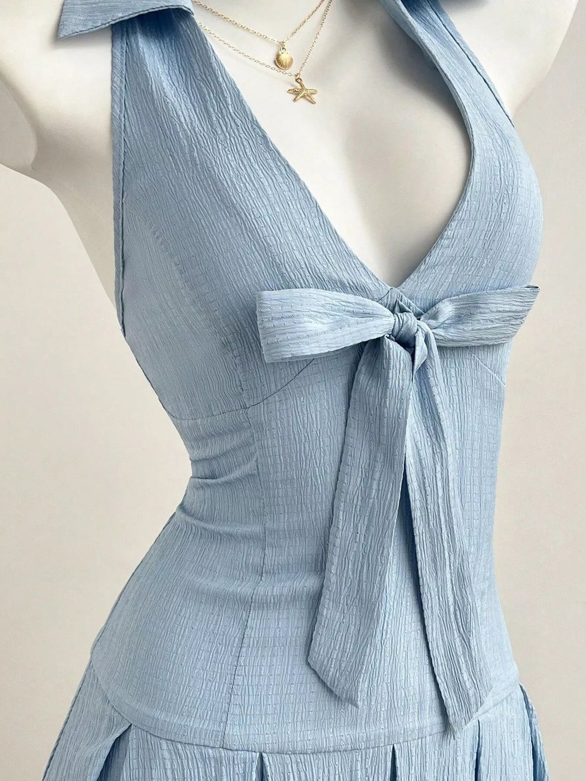 Pleat detail on a light blue mini dress