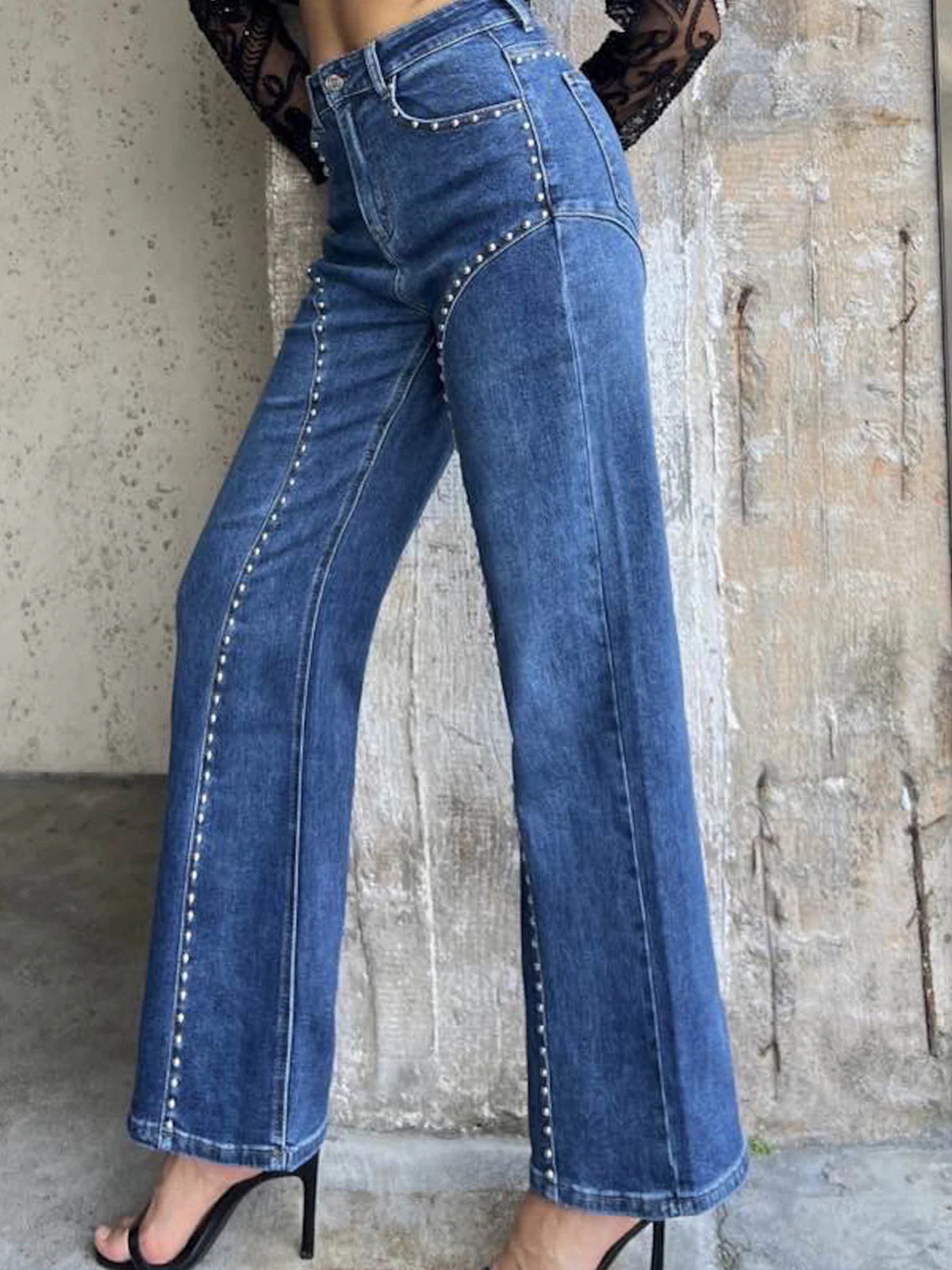 Studded wide leg jeans showing hardware detail