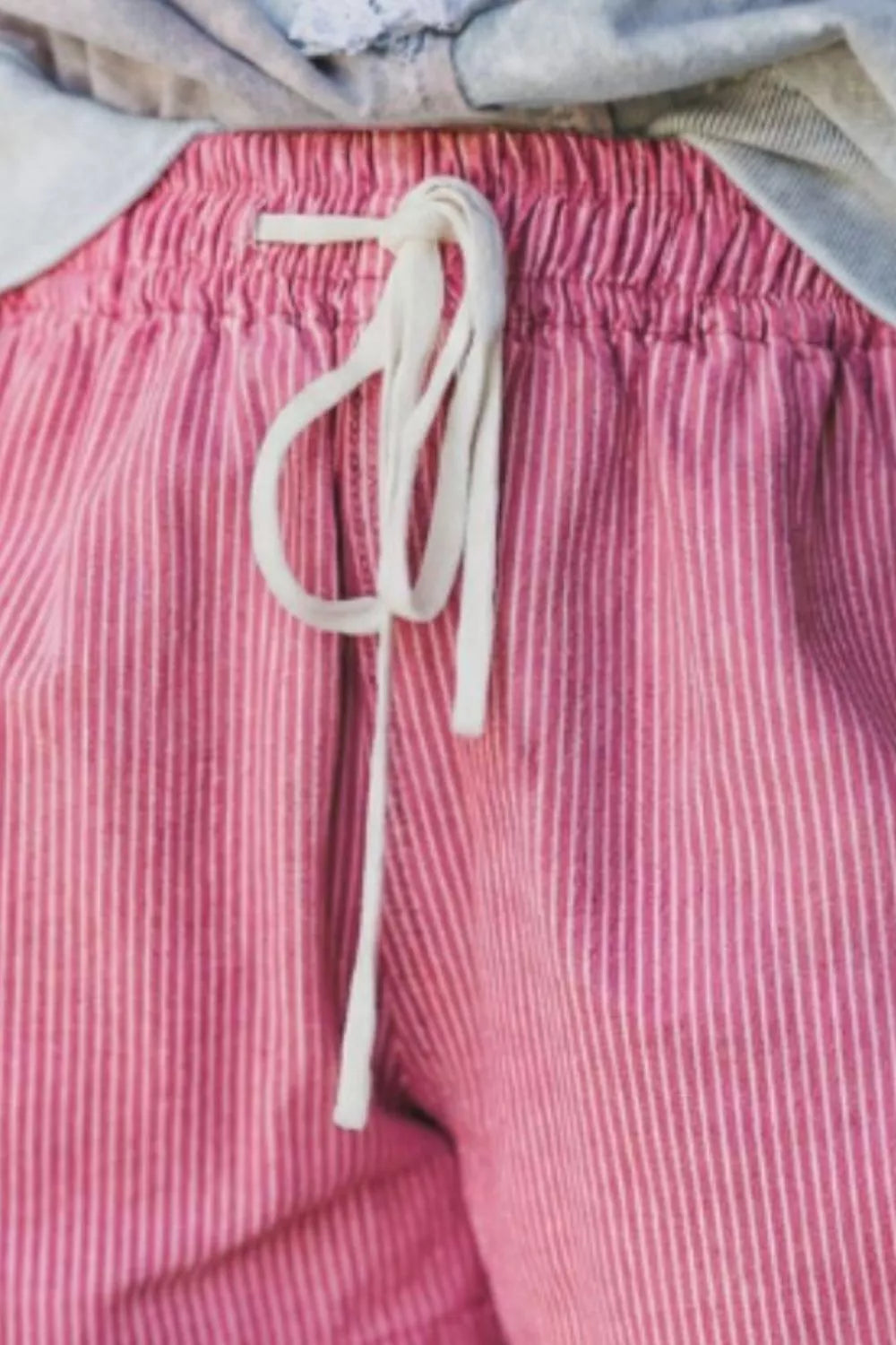 Pink striped elastic waist shorts, side view