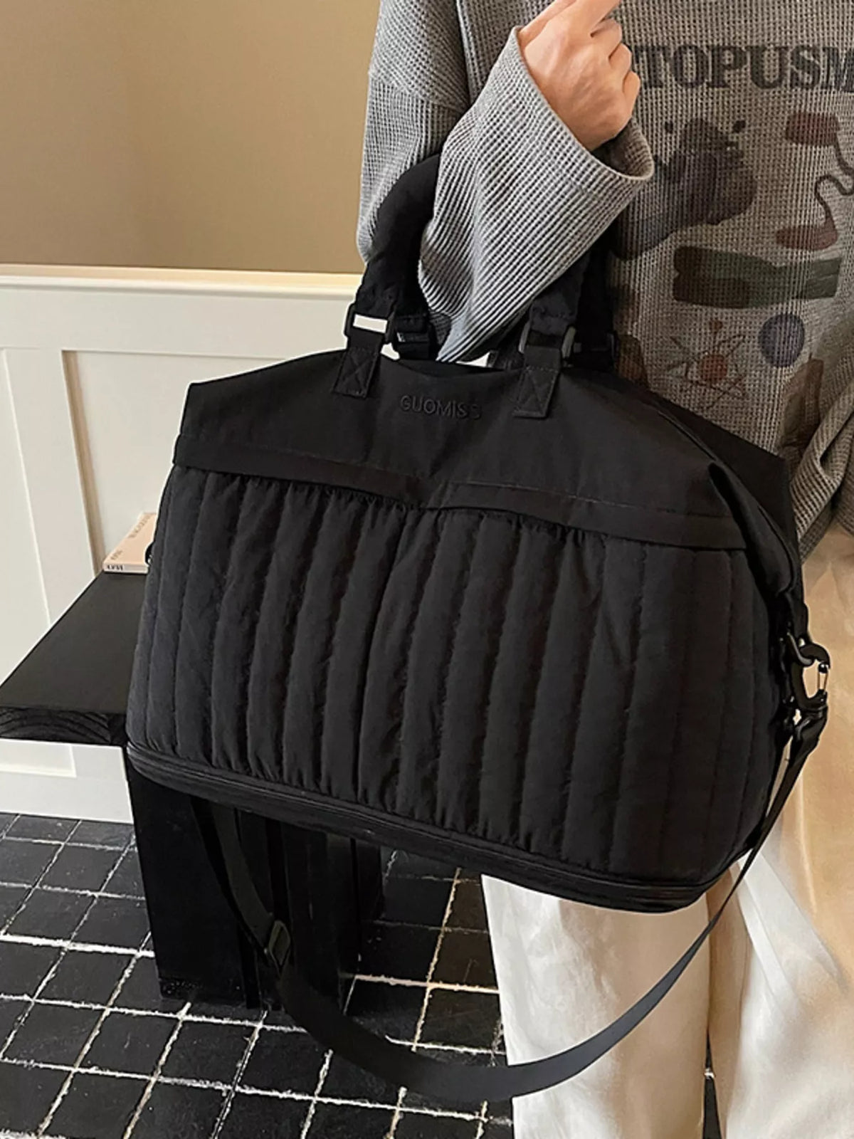 Quilted duffel side view with handles