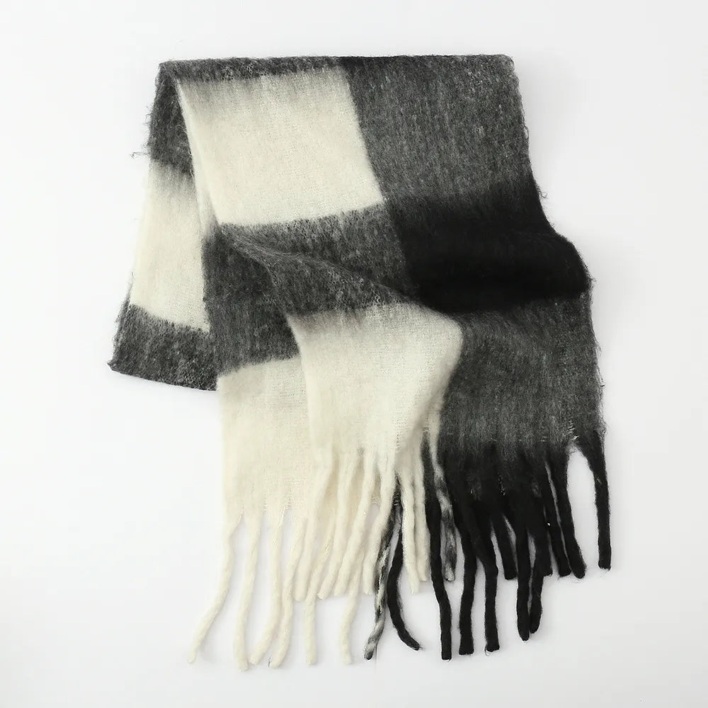 Oversized plaid scarf styled over a coat