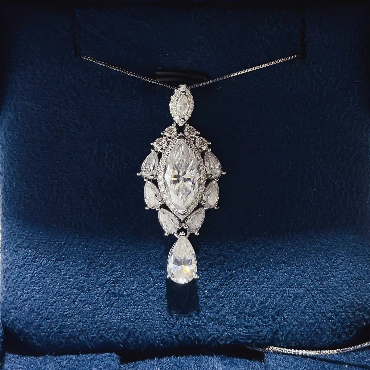 Close up of moissanite stone and silver setting on pendant
