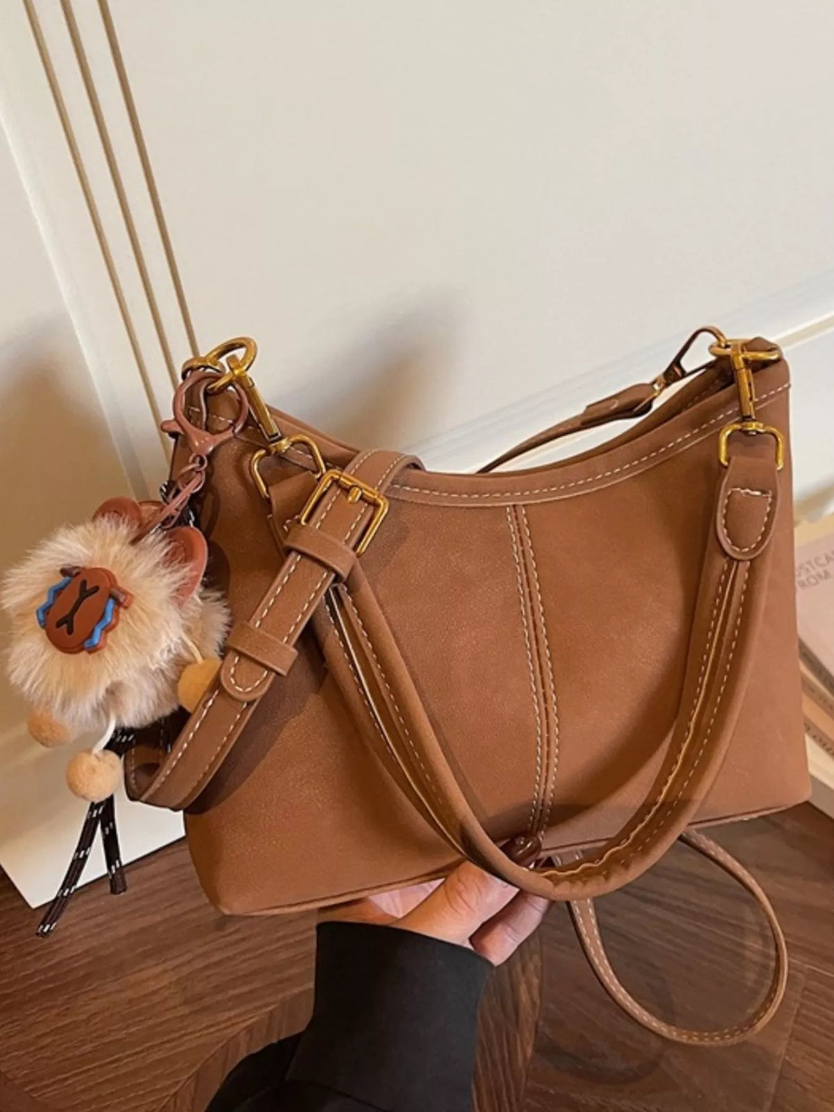 Adjustable strap detail on caramel bag