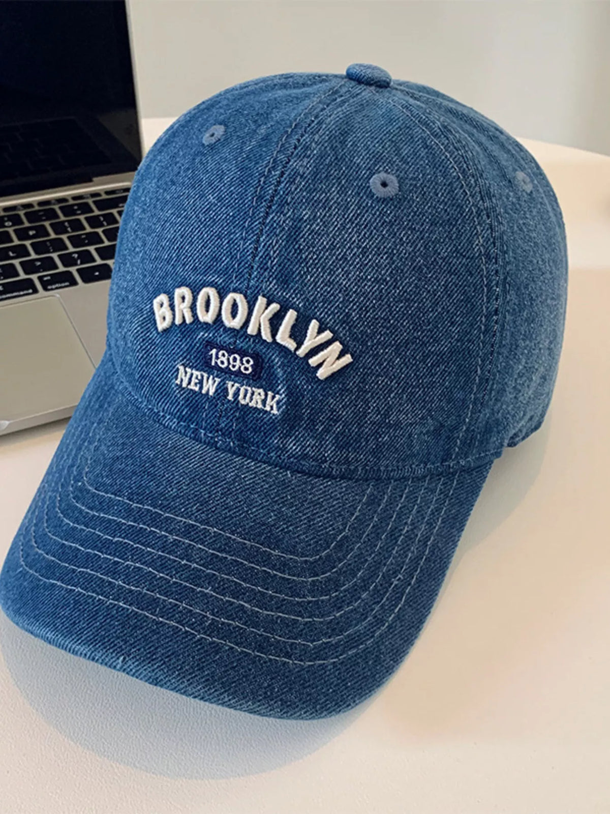 Letter embroidered baseball cap brim detail