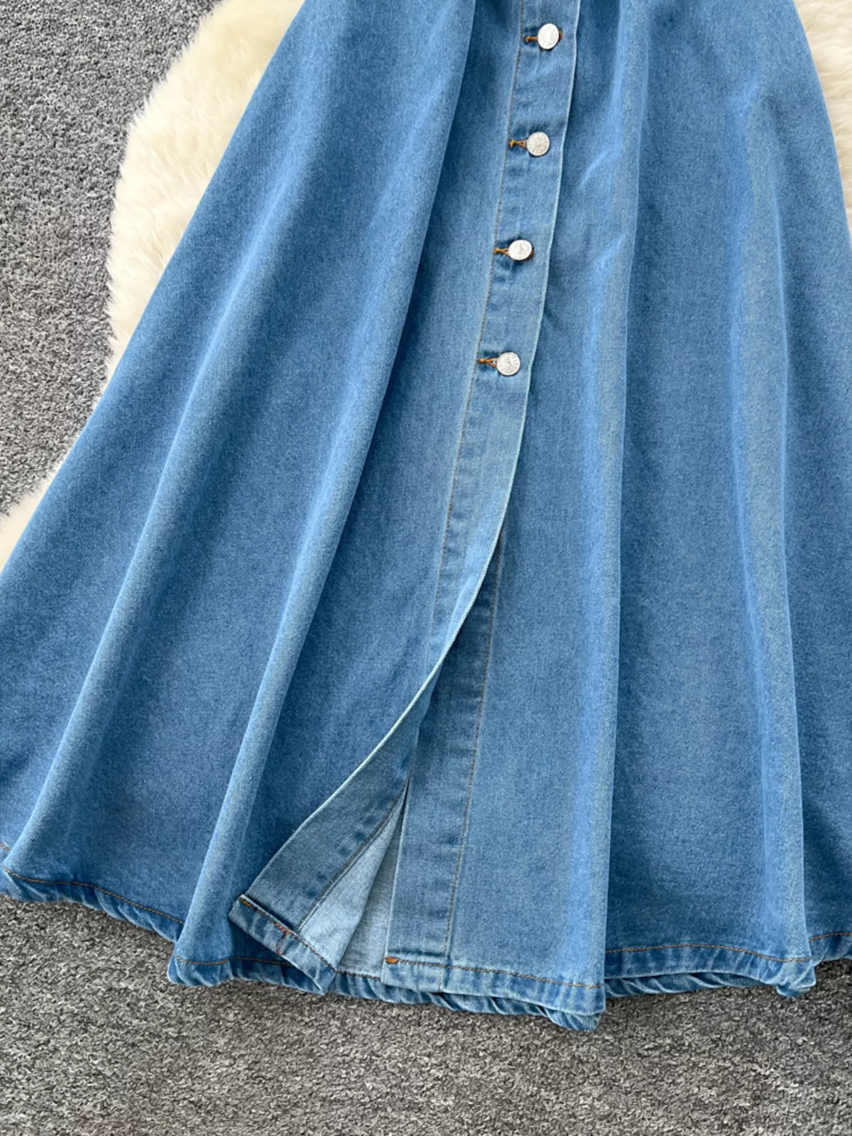Blue halter neck button down denim dress on model