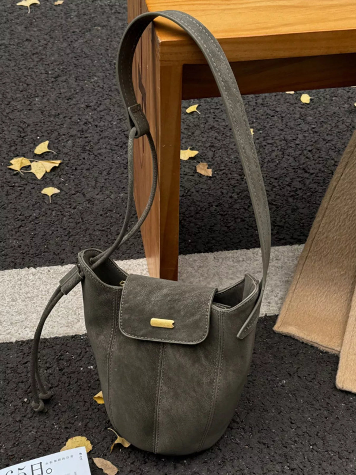 Green suede bucket bag side profile